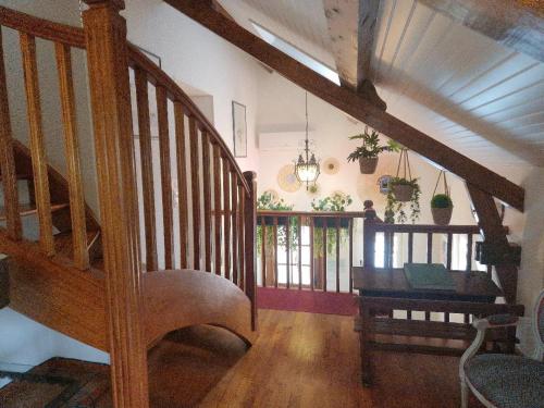 a room with a staircase and a table in a house at Domaine Garmidou in Lucq-de-Béarn