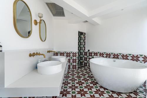 a bathroom with a large white tub and a sink at Misty Nest High Altitude River View B&B Hongyadong Branch in Chongqing