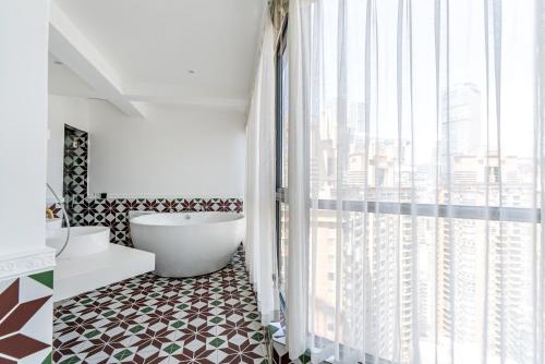 a bathroom with a tub and a large window at Misty Nest High Altitude River View B&B Hongyadong Branch in Chongqing