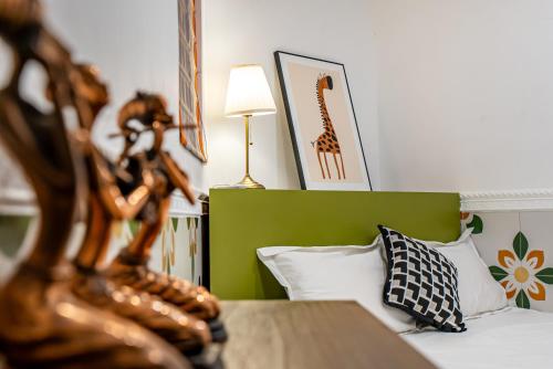 a bedroom with a bed with a green headboard at Misty Nest High Altitude River View B&B Hongyadong Branch in Chongqing