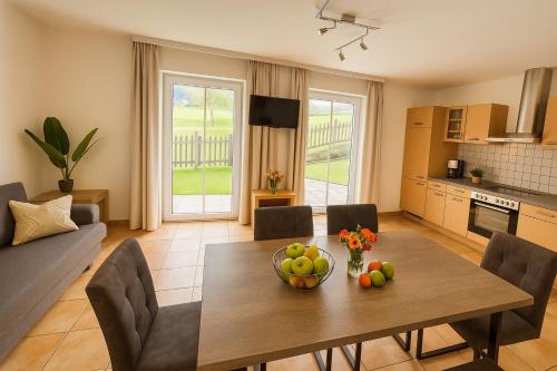a living room with a table with a bowl of fruit at Appartementhaus Flattach Goritschnig in Flattach
