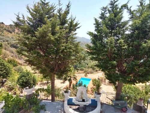 a villa with a swimming pool and trees at Vista Alcantara - Wellness Mountain-Top Retreat in Motta Camastra