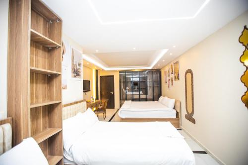 a hotel room with two beds and a couch at Global Comfort Inn in Cairo