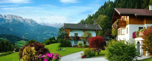 a house on a hill with mountains in the background at Haus Silvia in Werfenweng