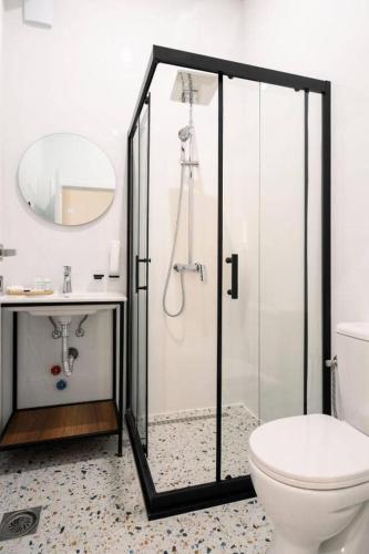 a bathroom with a shower with a toilet and a sink at Harmonia Apartments in Bitola