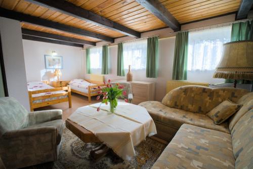 a living room with two couches and a table at Agroturystyka Uroczysko in Sianów
