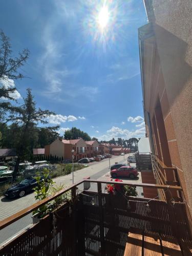 a balcony of a building with the sun in the sky at Twoja Przystań SŁAWA- Apartament przy plaży in Sława