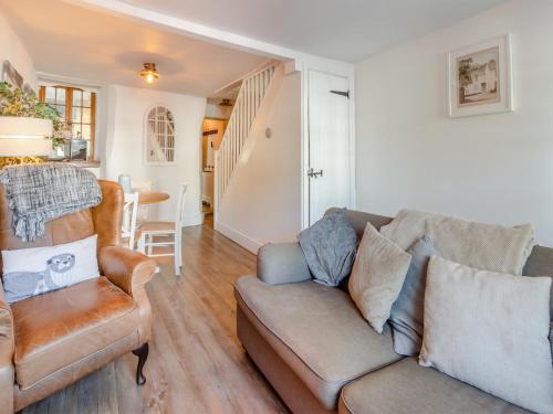 a living room with a couch and a chair at Daisy Cottage in Shaldon