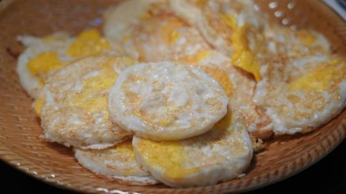 a plate of pancakes with powdered sugar on top at Fairfield by Marriott Yining in Yining