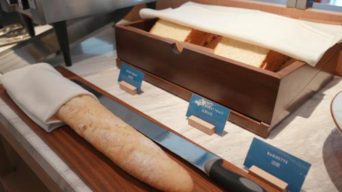 a display case with a loaf of bread and a knife at Fairfield by Marriott Yining in Yining