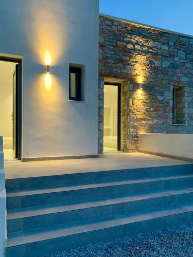 a set of stairs leading to a stone building at AiΘeria Suites Ios - Room Avra in Ios Chora