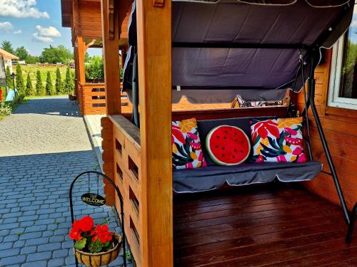 a bed with pillows and a bowl of watermelon at Noclegi "LAS WYPAS" Trzcianka in Trzcianka
