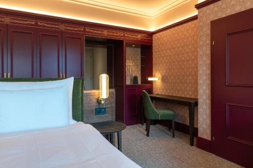 a hotel room with a bed and a desk at Cresta Palace Celerina St Moritz active-in and experience-out in Celerina
