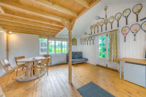 a dining room with a table and chairs at Railway Carriage accommodation with tennis court! in Walberton
