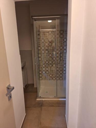 a shower with a glass door in a bathroom at DGD house in Carrara