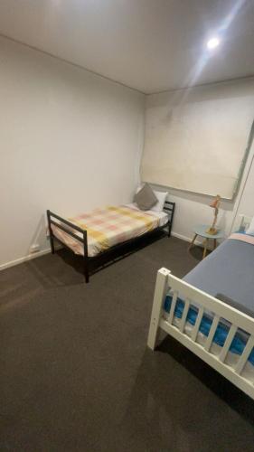 a bedroom with two beds in a room at Modern 3BR home, Close to parliament , Canberra in Griffith