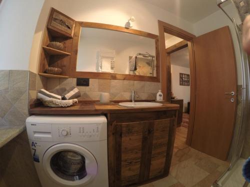 a bathroom with a washing machine and a sink at Appartamento Pré-Saint-Didier, terme in Pré-Saint-Didier