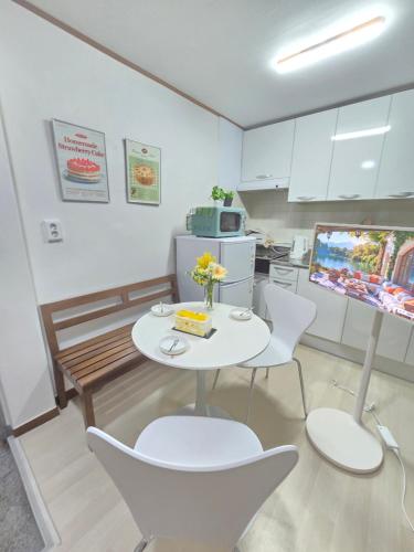 a kitchen with a table and chairs and a tv at Daechi, Good stay,gang nam in Seoul