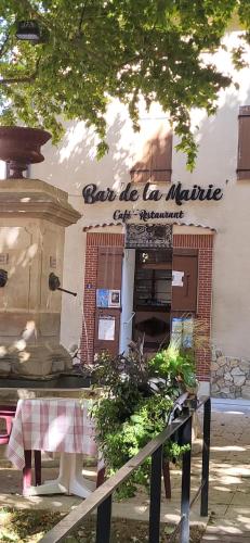 a restaurant with a table in front of a building at Domaine Saint Roch in Saint-Paul-lez-Durance
