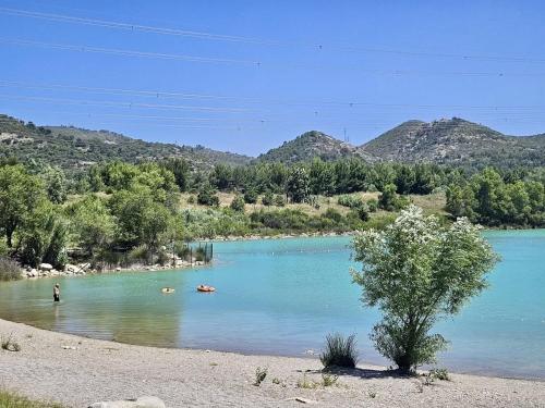 a river with people swimming in the water at Domaine Saint Roch in Saint-Paul-lez-Durance