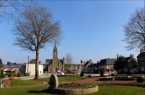 a small town with a church and a cemetery at Cosy rental - Normandy in Sourdeval