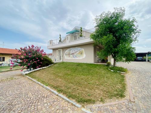 a house with a large yard in front of it at B&B Marzia in Cuneo