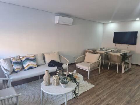 a living room with a couch and a table at Espinho Charm Stay in Espinho
