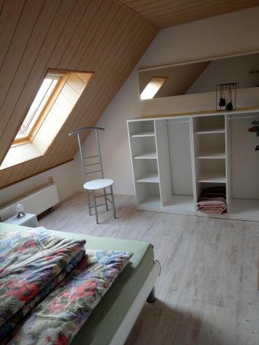 a attic bedroom with a bed and a window at Ferienwohnung Schlesinger in Hohnstein