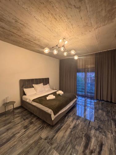 a bedroom with a large bed and a window at The Cave Garden in Cluj-Napoca