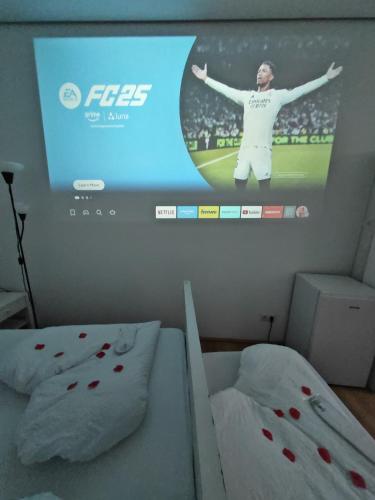 a tv screen in a bedroom with two beds at ABAI Apartments 1140 only WWW-On-line-Check-in & SelfService in Vienna
