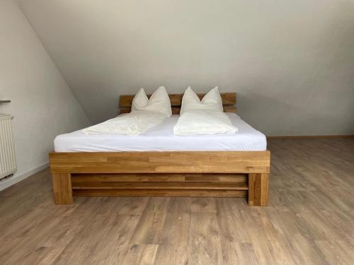 a bed with three pillows on it in a room at Ferienwohnung Sonnenschein in Kappel-Grafenhausen