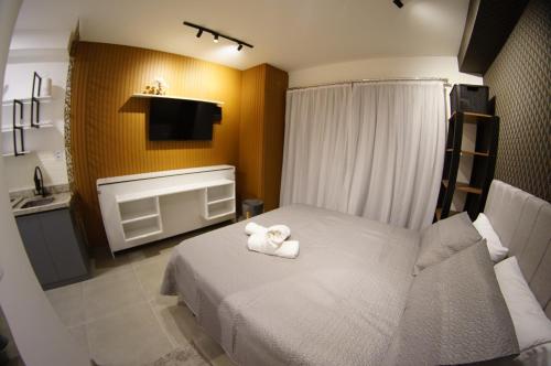 a bedroom with a bed with two towels on it at Studio Aconchegante in Sao Paulo