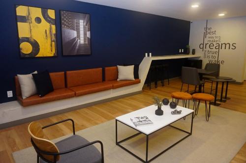 a living room with a couch and a table and chairs at Studio Aconchegante in Sao Paulo