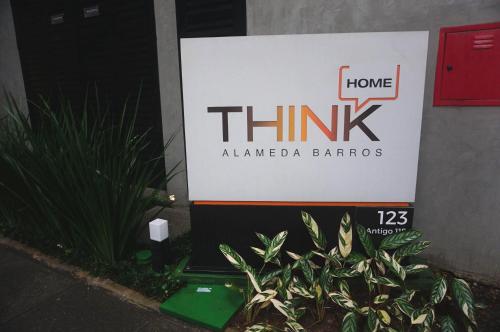 a sign for a thinkaligned barros in front of a building at Studio Aconchegante in Sao Paulo