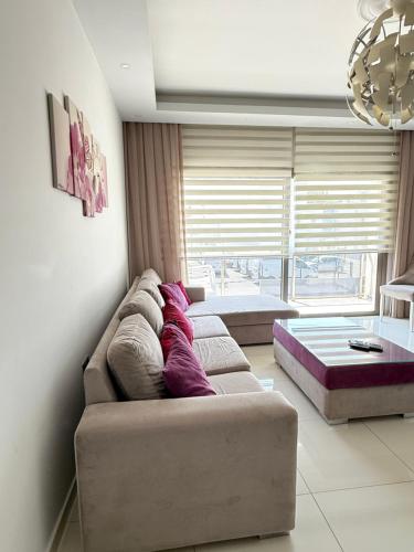 a living room with a couch and a large window at Nicosia's Diamond in Nicosia