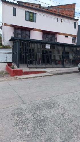 a building with a black fence in front of a street at La Estrella 2 in Dosquebradas