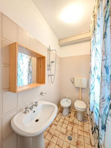 a bathroom with a sink and a toilet at Locanda San Marco in Caorle