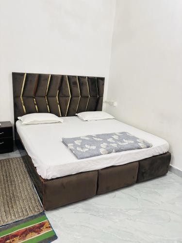 a bed sitting in a room with a mattress at Kanak Bihari Yatri Niwas, 100 Meter Ram Ki Paidi, Saryu River in Ayodhya
