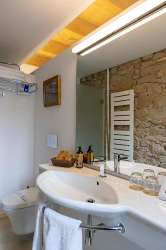 a bathroom with a white sink and a mirror at Hotel La Freixera in Solsona