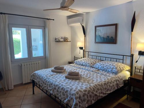 a bedroom with a bed with two pillows on it at Villa Balcon al Mar in Jávea