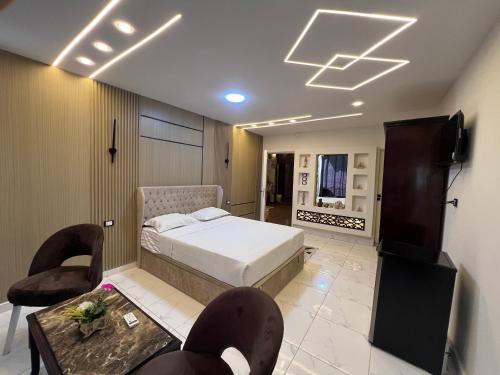 a bedroom with a bed and a table and chairs at Miracle Pyramids View Hotel in Giza