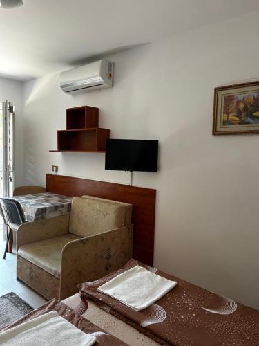 a living room with a couch and a table at Birta Apartman in Hajdúszoboszló