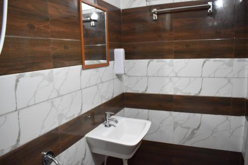 a bathroom with a sink and a mirror at Aishwaryam home stay in Madurai
