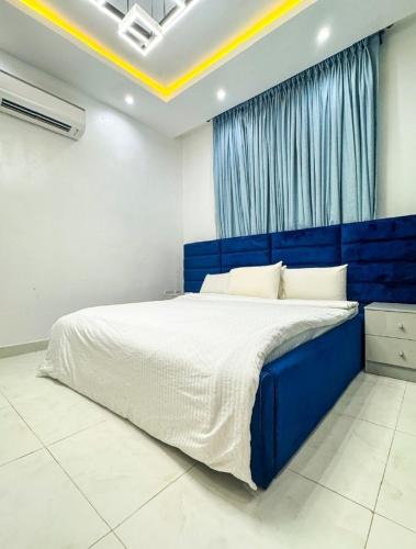 a bedroom with a large blue bed in a room at Executive 2 bedroom apartment in Lagos