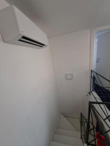a staircase in a room with a white wall at Bella Blu in Gaeta