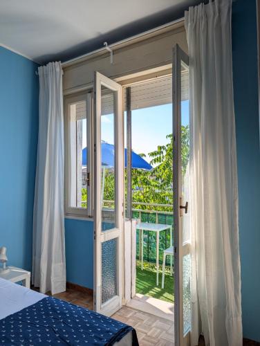 a bedroom with a door open to a balcony at Locanda San Marco in Caorle