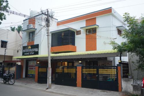 a building on a street with a store at Aishwaryam home stay in Madurai