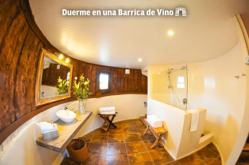 a bathroom with a tub and a sink and a shower at Cava Colchagua Hotel Boutique in Santa Cruz