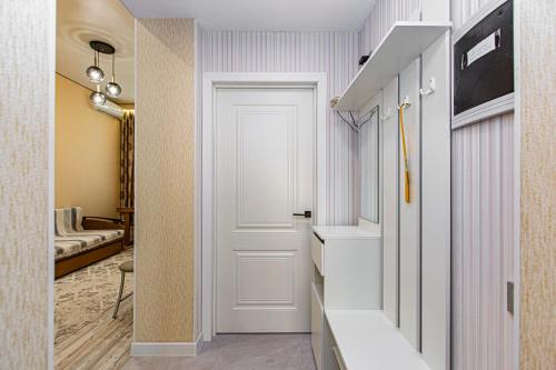 a hallway with a door leading into a room at Шикарная Двушка в самом центре Алматы #12 in Almaty