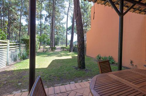 a patio with a table and chairs in a yard at Aroeira - Nature, Beach & Golf, by TimeCooler in Almada